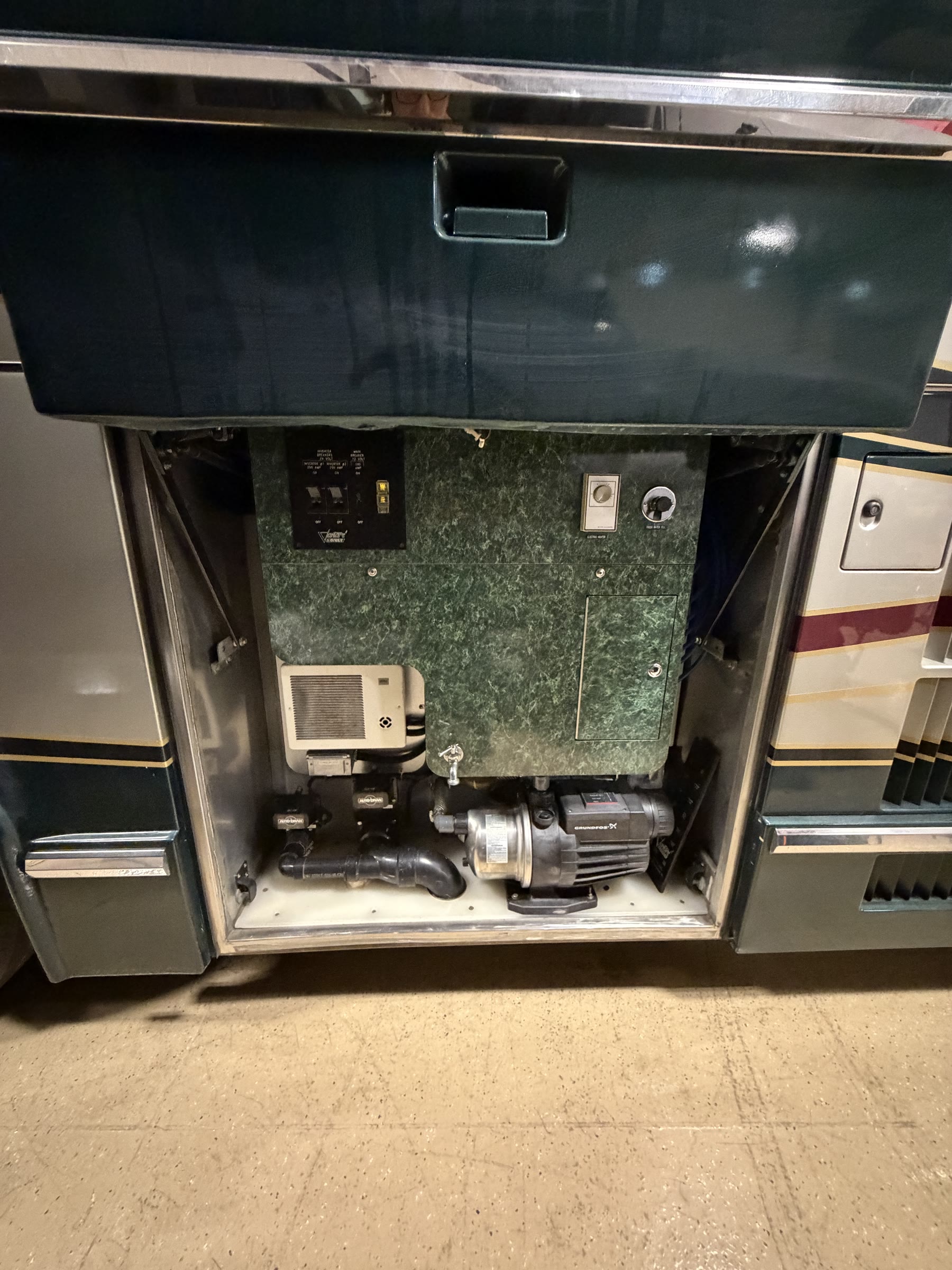 Shore power panel and Grundfos water pump bay